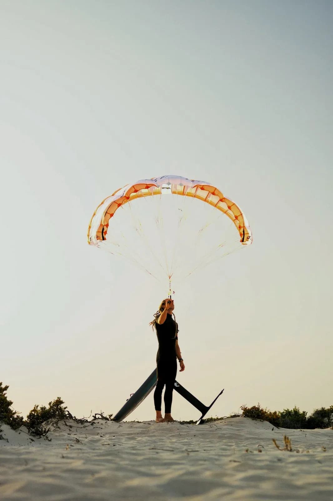 Rider on a dune holding the STOW overhead