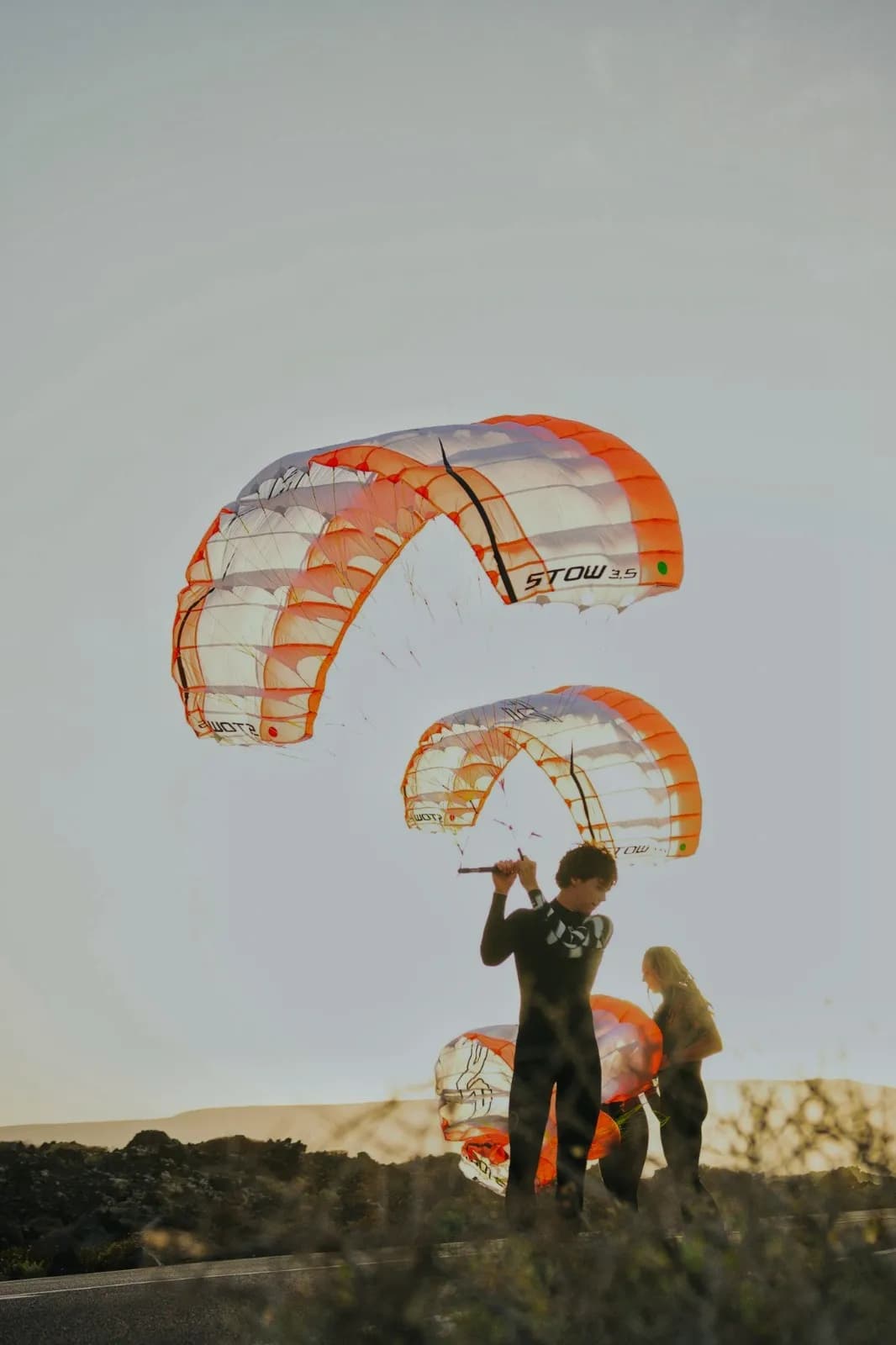 Two inflated STOW parawings at sunset